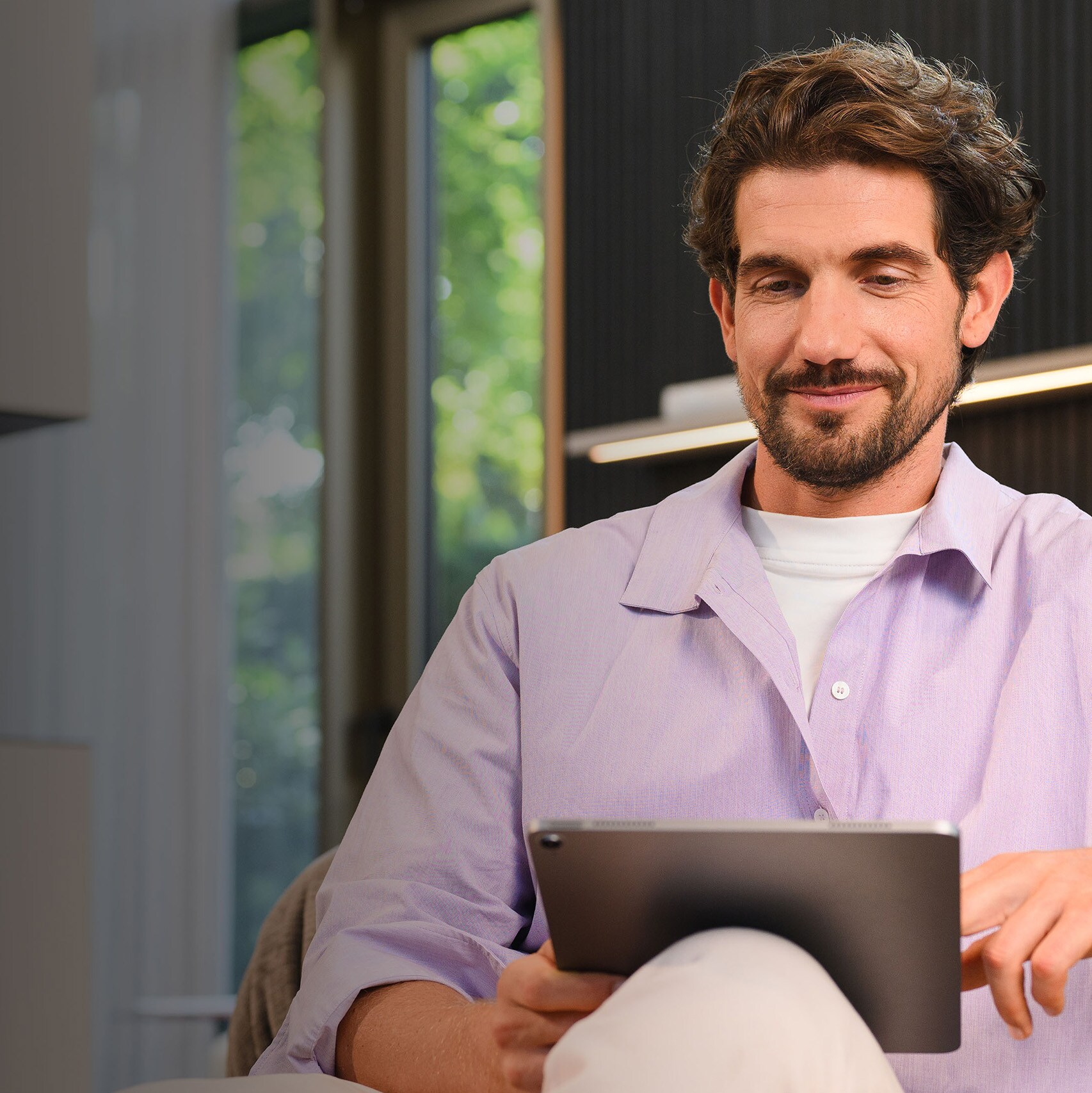 A person on his tablet looking Mercedes-Benz Insurance options for his Mercedes-Benz Van