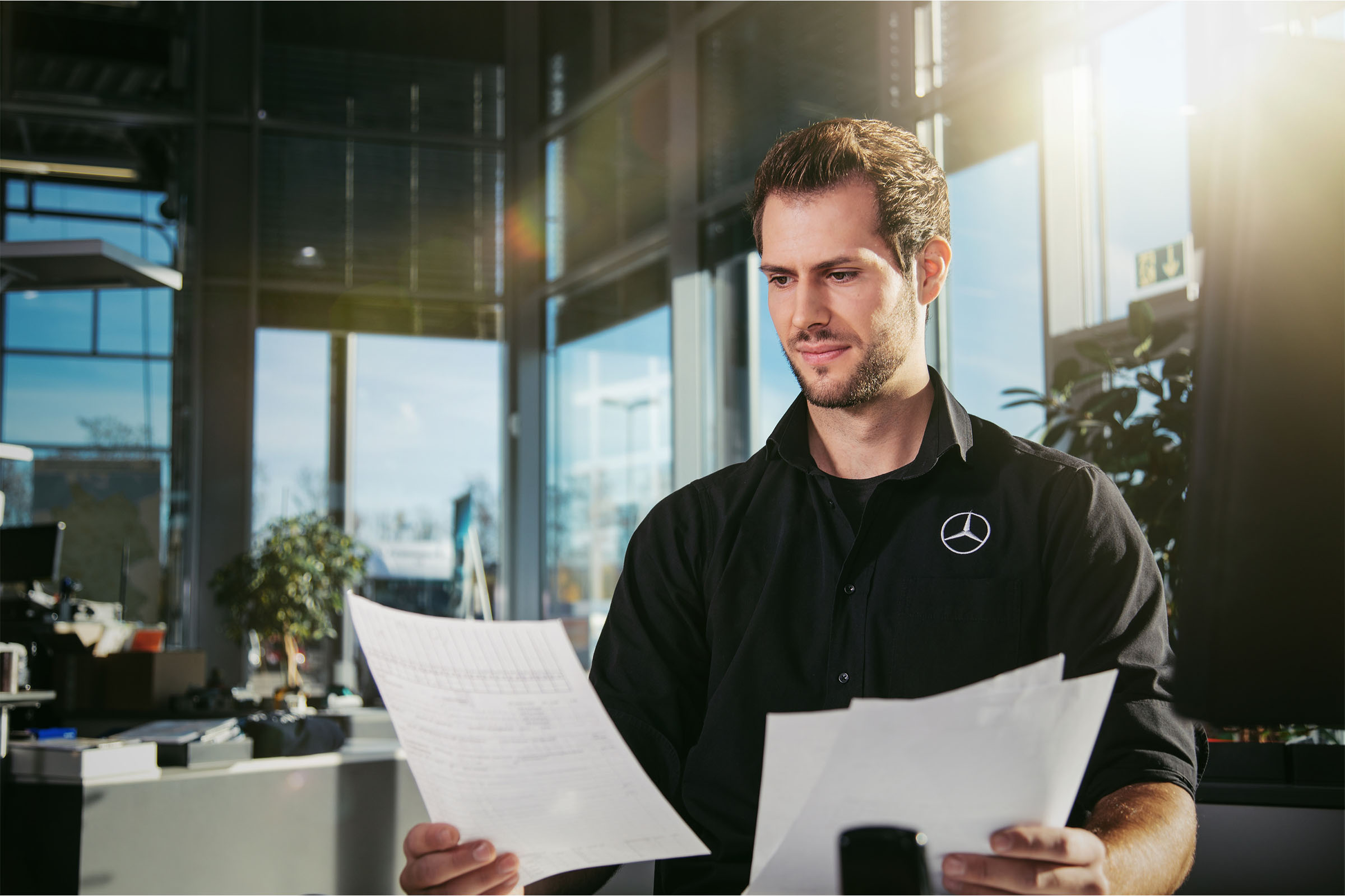 Why choose Mercedes-Benz Vans? A man holding some documents