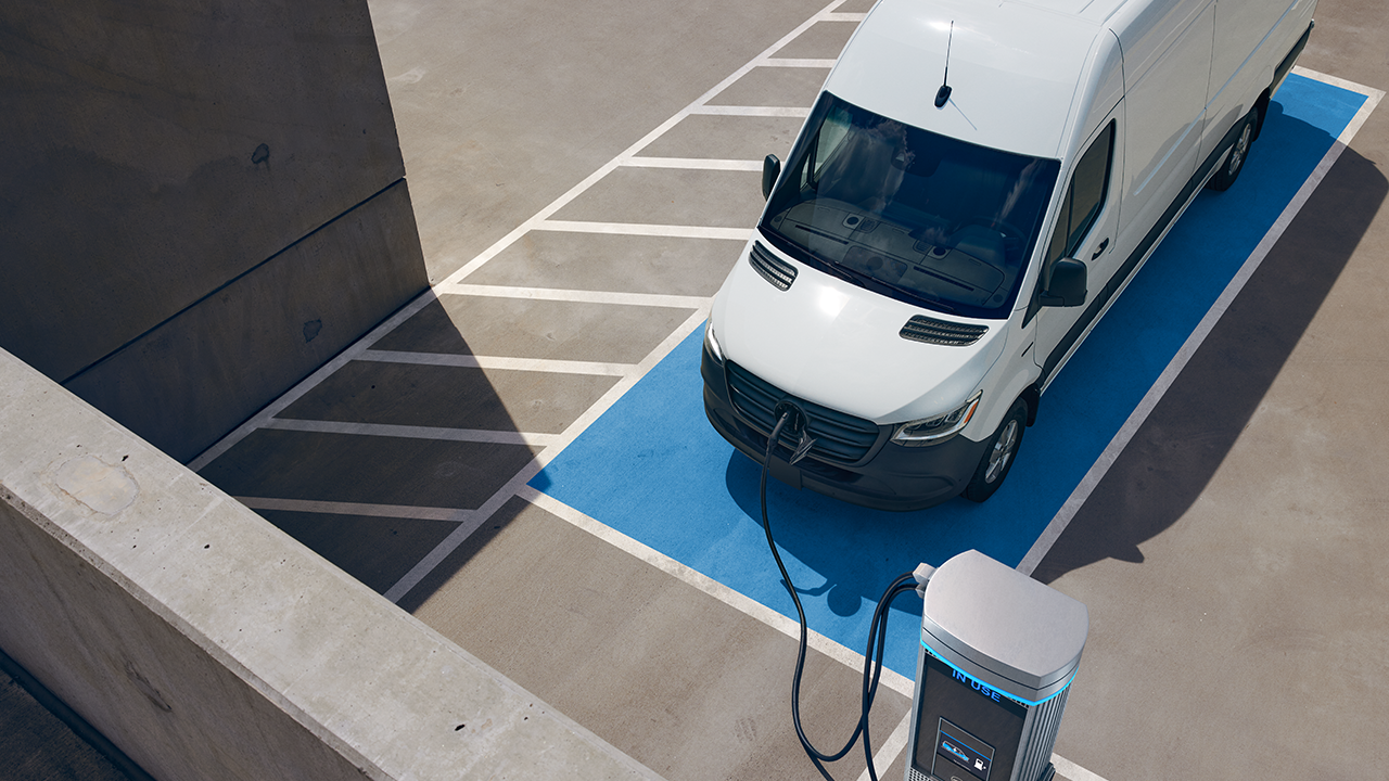 The second generation eSprinter Panel Van | Commercial Vehicles History | Mercedes-Benz Mercedes-Benz eSprinter Panel Van delivery van driving through modern city street