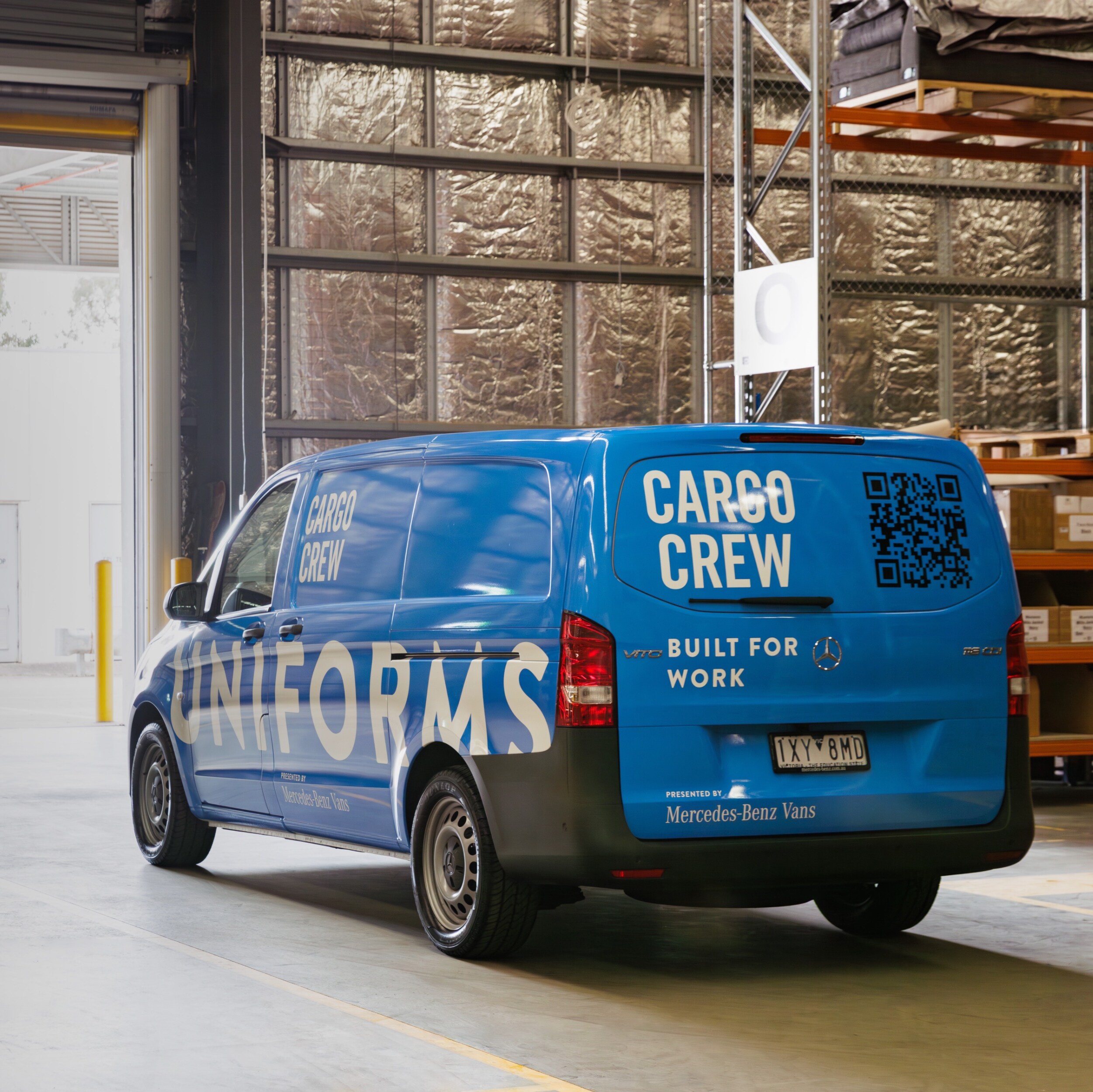 A blue van parked in front of roller door with person walking through. Image credit/photographer: XMEDIA  
