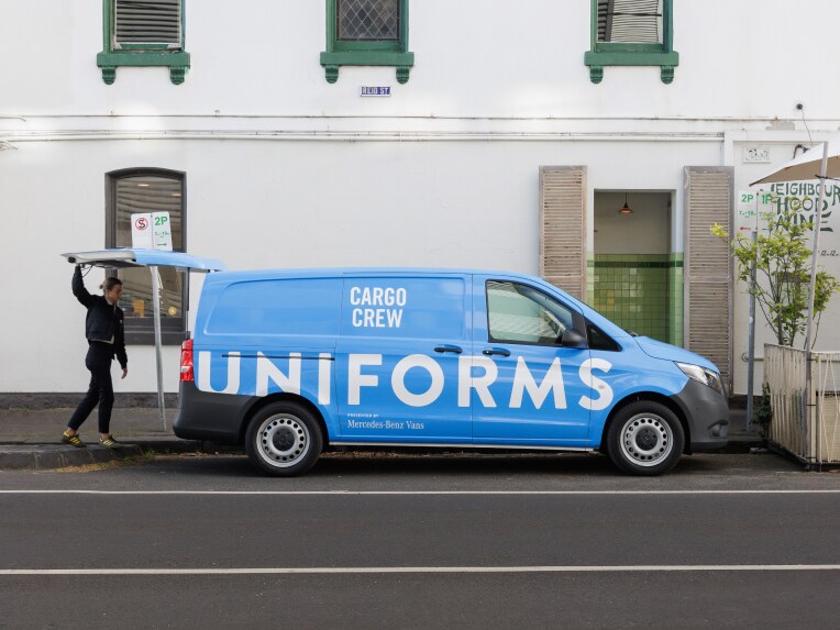 A van with clothes hung up in back and drawers open full of apparel.