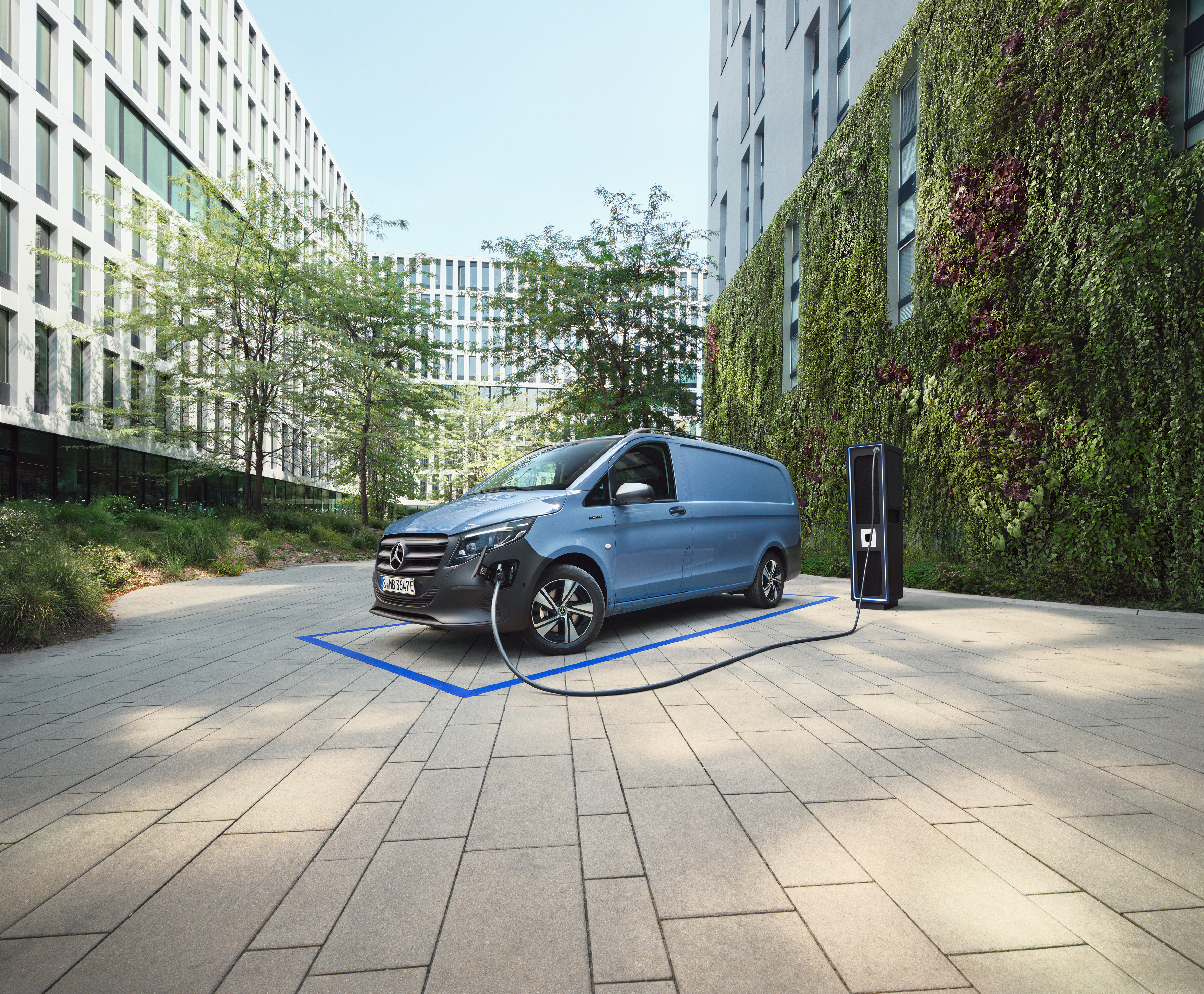 Mercedes-Benz electric van lineup | Commercial Vehicles History | Mercedes-Benz Mercedes-Benz electric van lineup displayed in futuristic warehouse with illuminated charging bars
