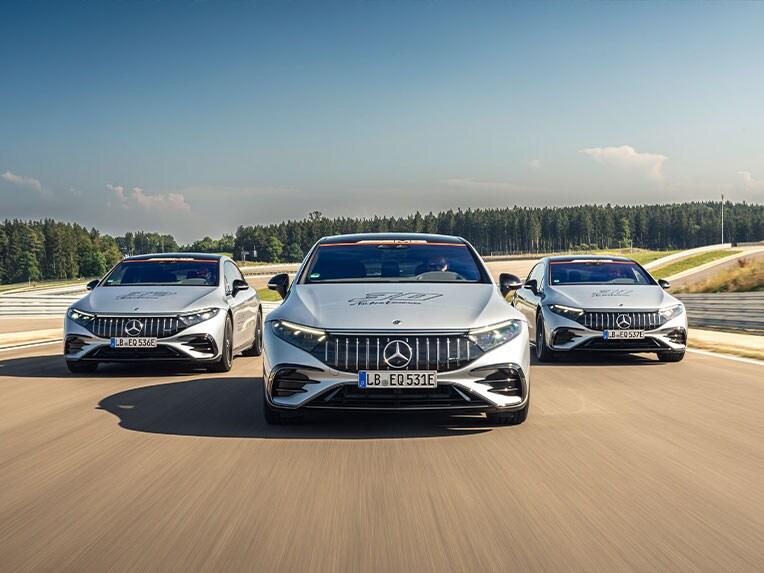 Three Mercedes-AMG models on a race track.