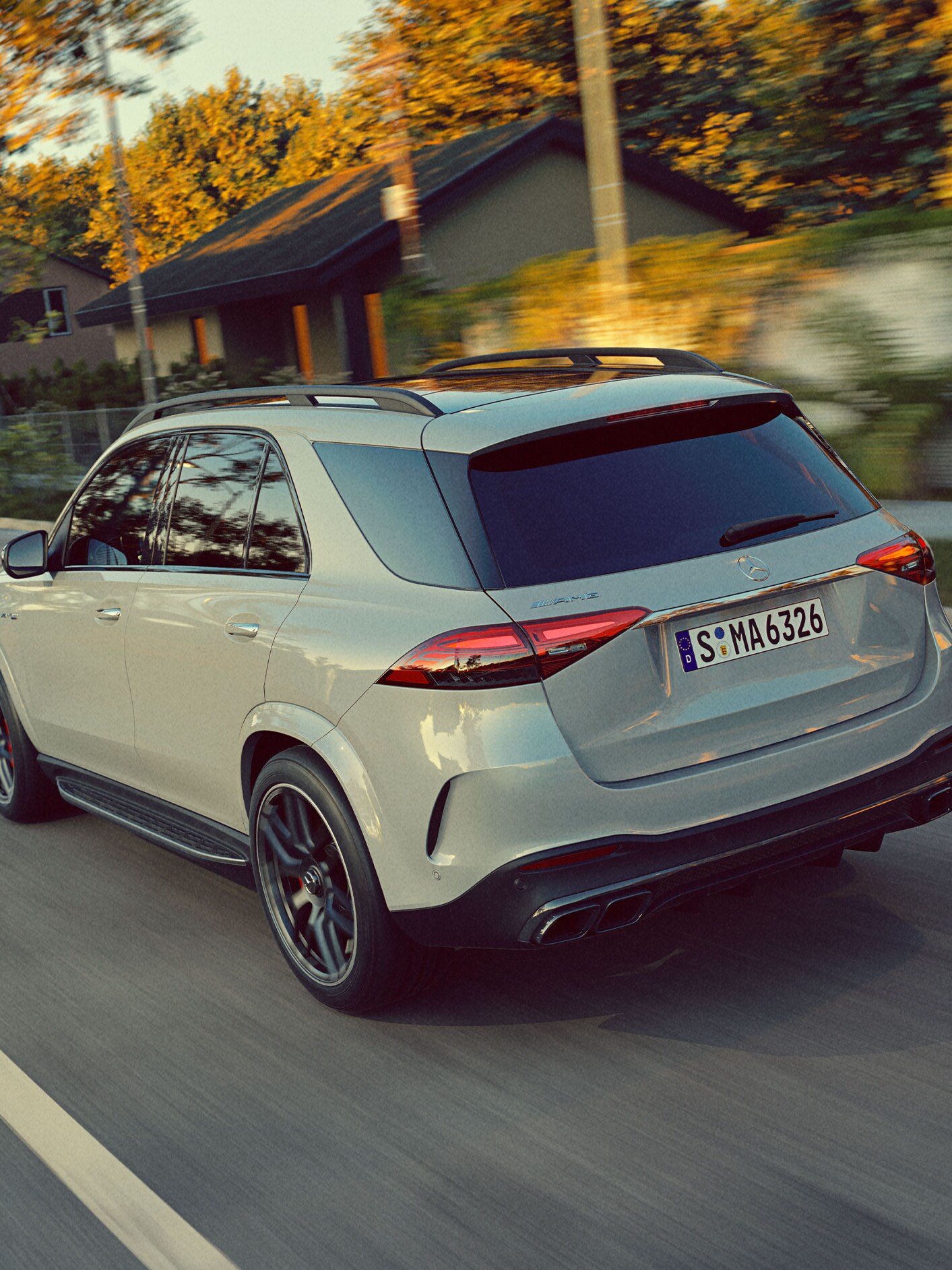 A rear view of the GLE SUV from Mercedes-AMG driving on a road.