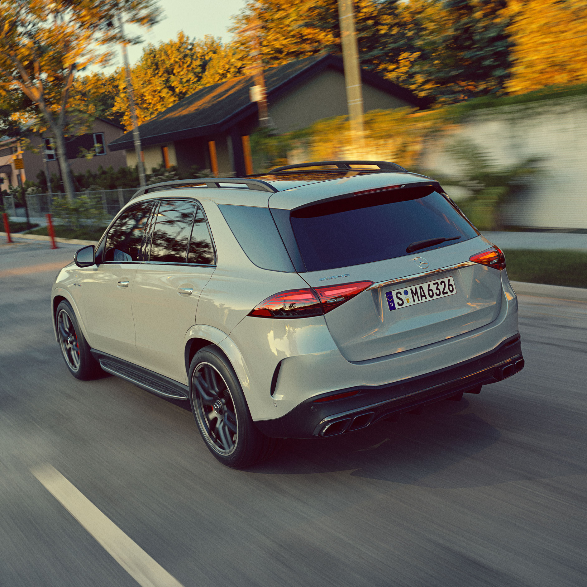 Performance | GLE SUV | Mercedes-AMG A rear view of the GLE SUV from Mercedes-AMG driving on a road.