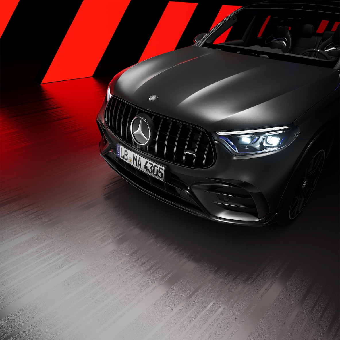 Side view on the front section of an Mercedes-AMG GLC SUV with AMG Exterior Night Package.