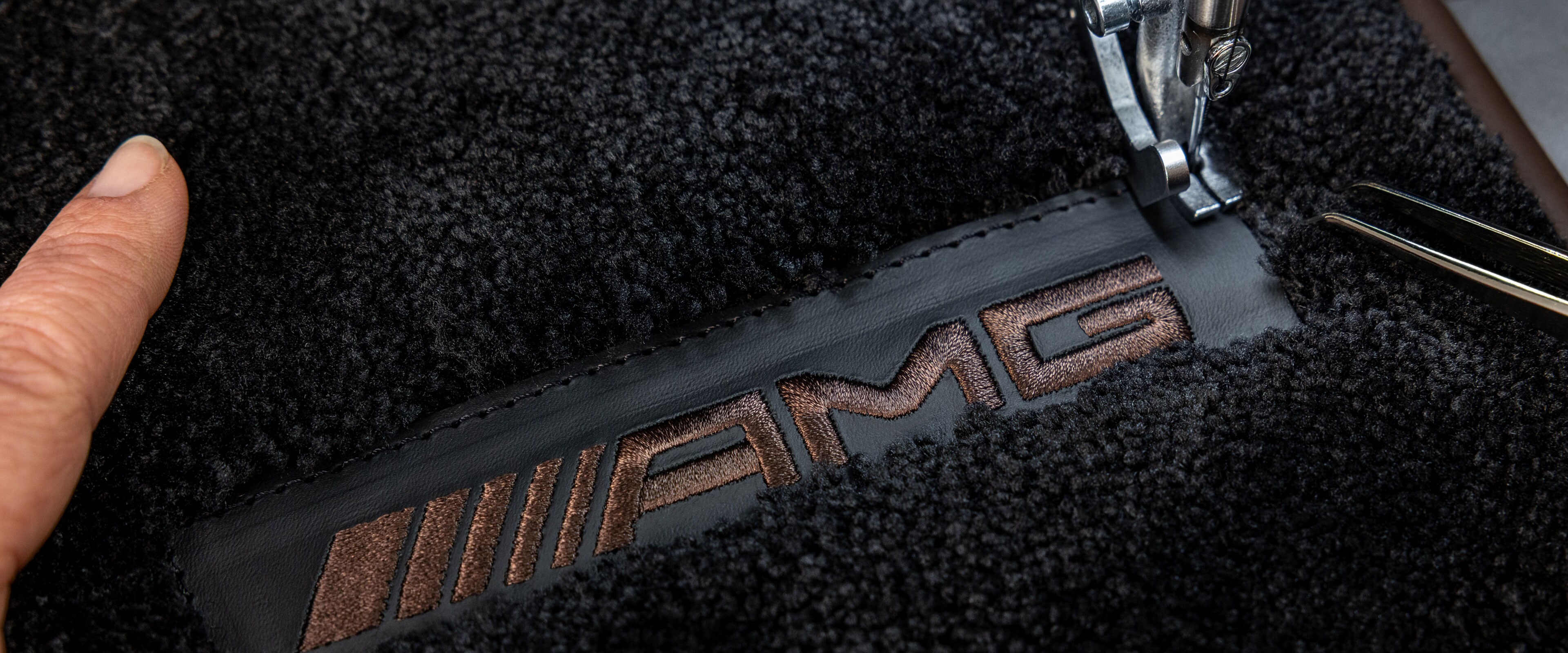 MANUFAKTUR lettering on a dark surface in a Mercedes-AMG.