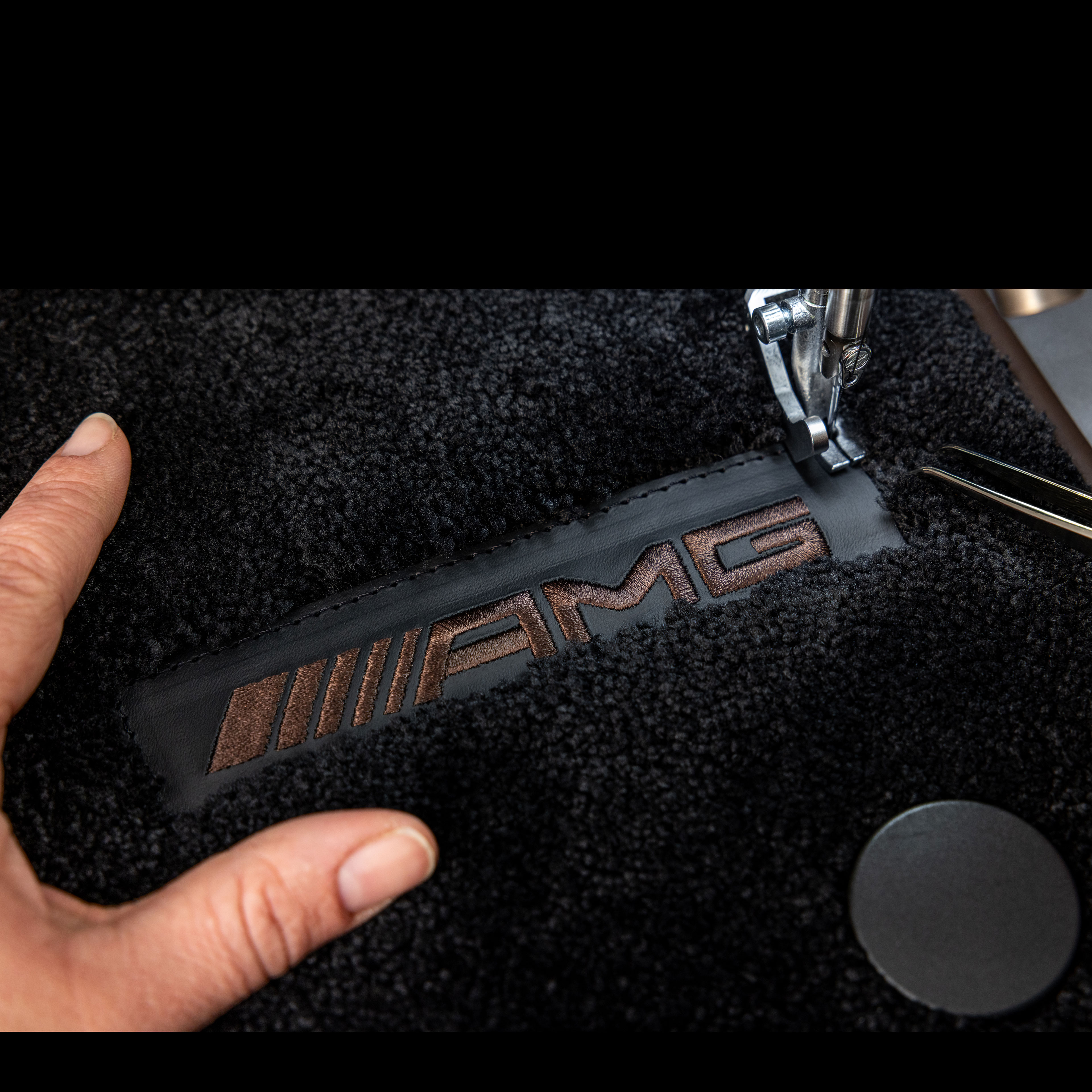 MANUFAKTUR | Mercedes-AMG MANUFAKTUR lettering on a dark surface in a Mercedes-AMG.