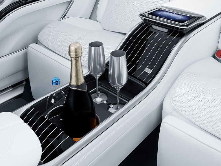 Refrigerated compartment with champagne goblets in the interior of the luxury Mercedes-Maybach EQS SUV.