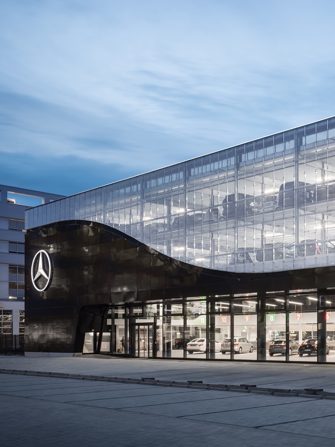 The image shows a service terminal of the Mercedes World in Berlin from the front.