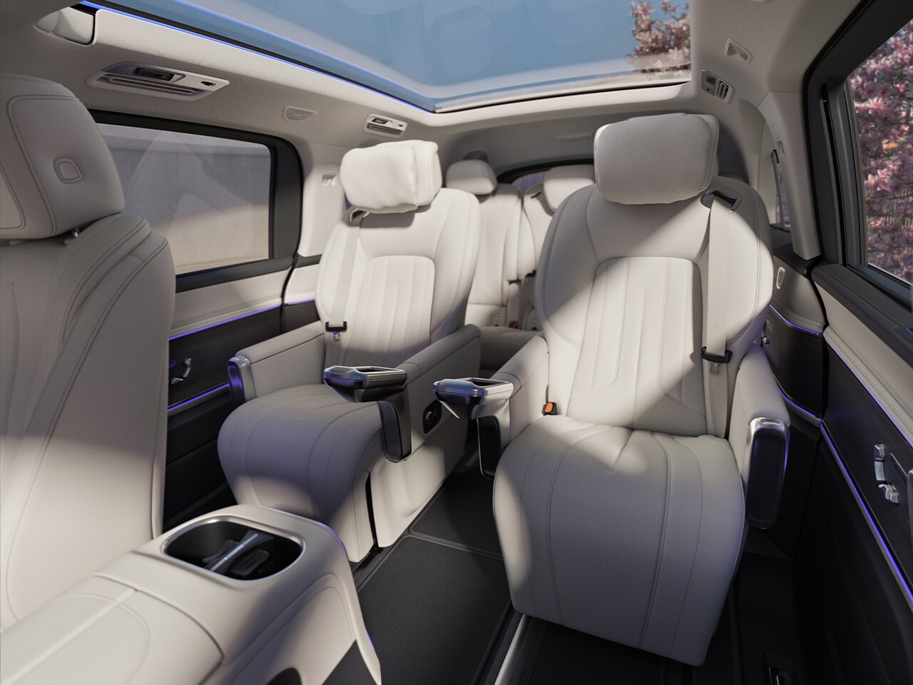 The rear compartment with cup holders, folding tables, USB-C ports, a temperature-controlled storage compartment, and storage drawers under the seats.