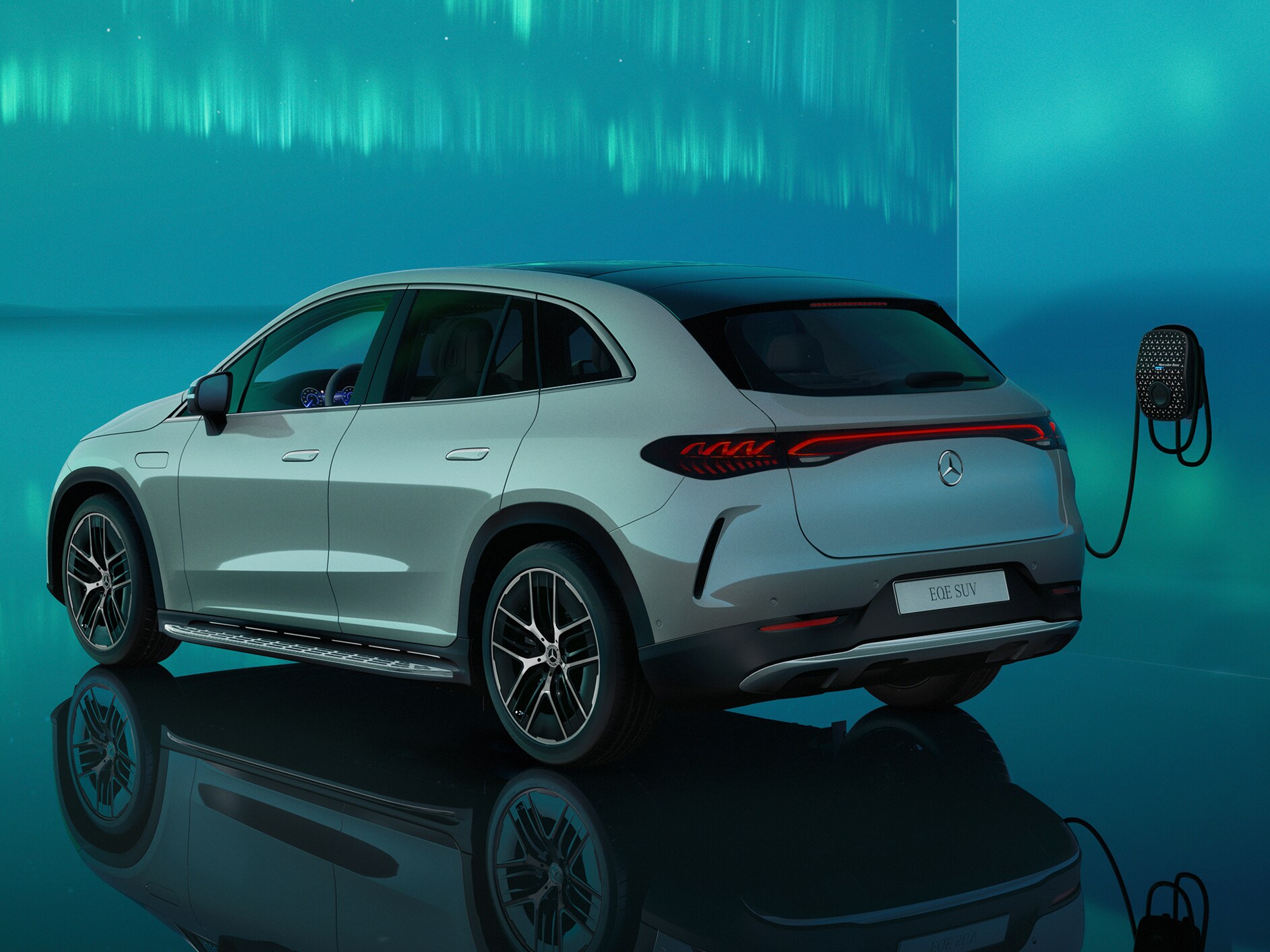 Side rear view of the EQE SUV charging at a Mercedes Benz Wallbox.