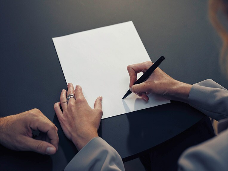 Woman signing paper