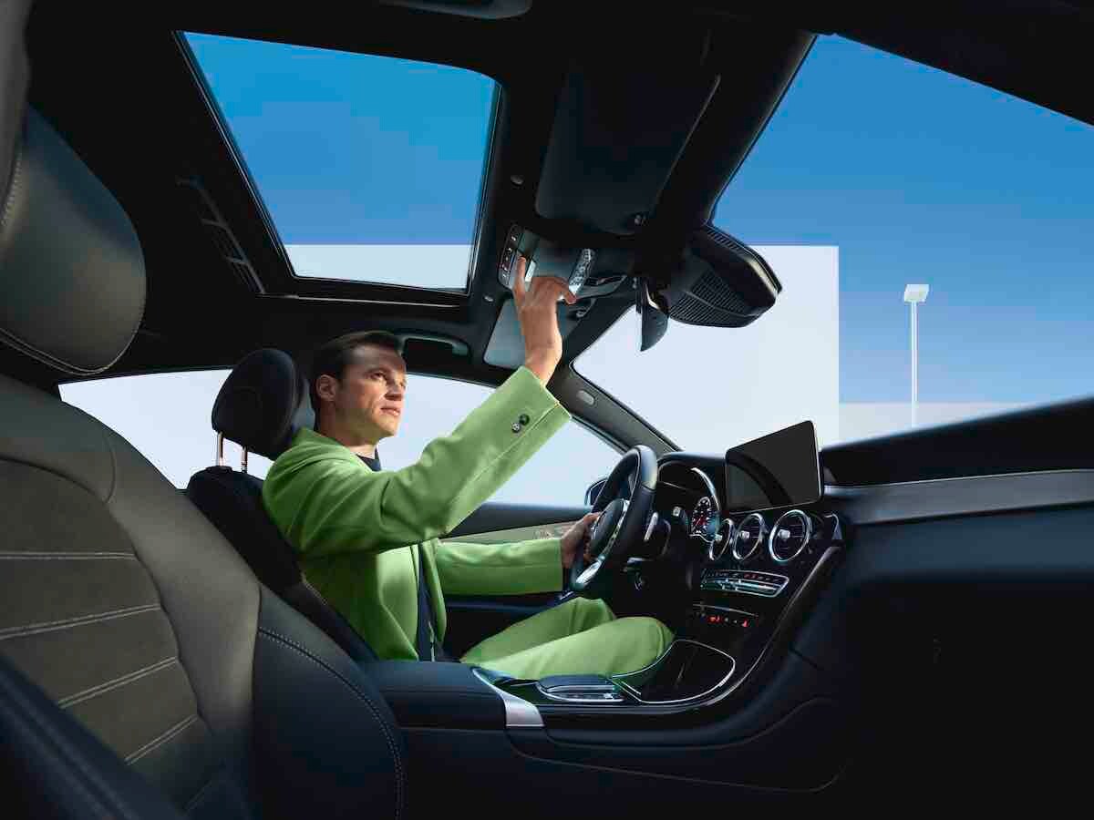 A man pressing the SOS button in his Mercedes-Benz.