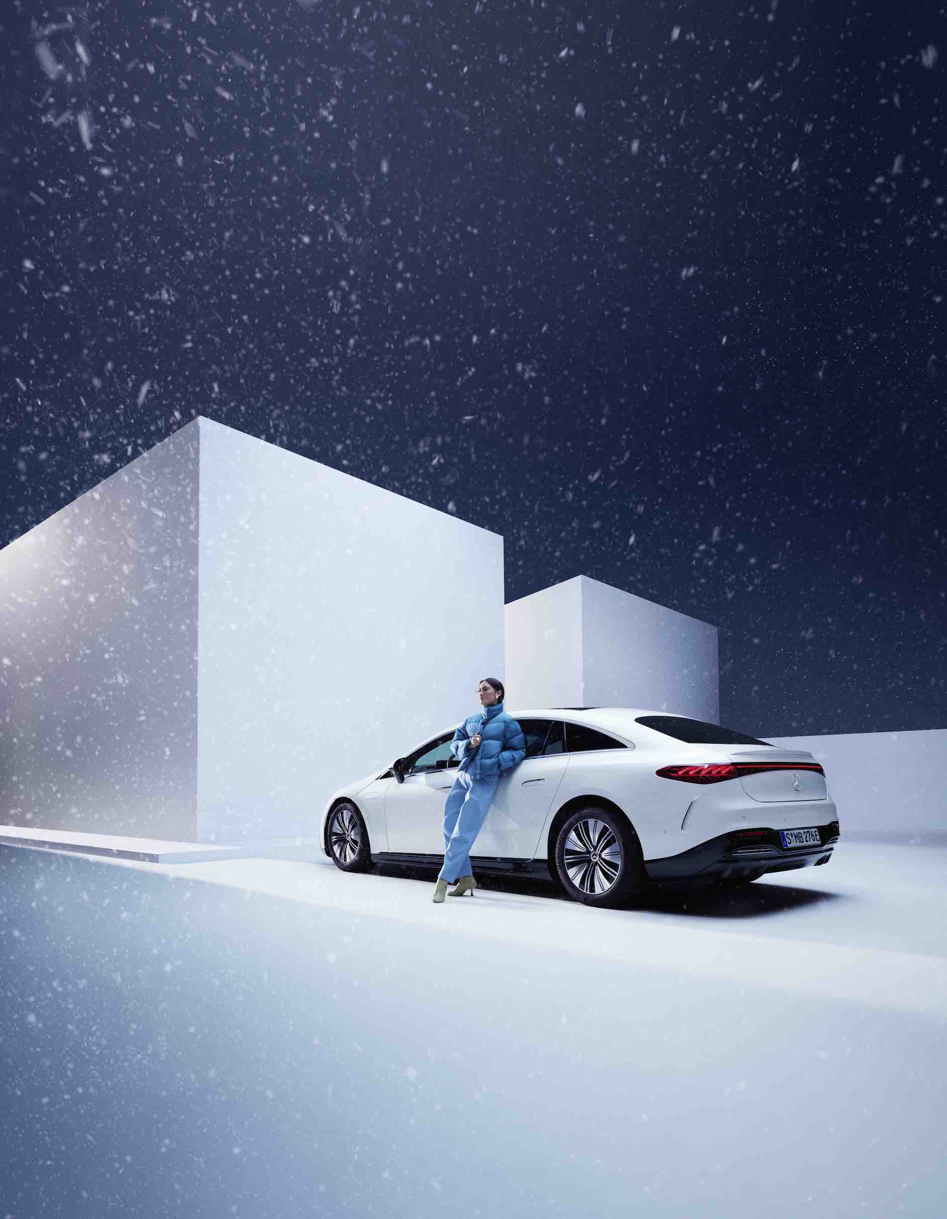 Mercedes-Benz | Genuine Car Care Products A woman leans on her Mercedes while it's snowing.