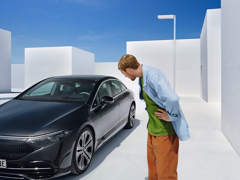 Man in front of a Mercedes-Benz.