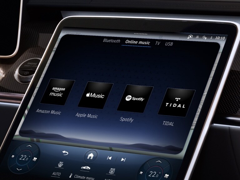 Various online music providers are displayed on the head unit of a vehicle.
