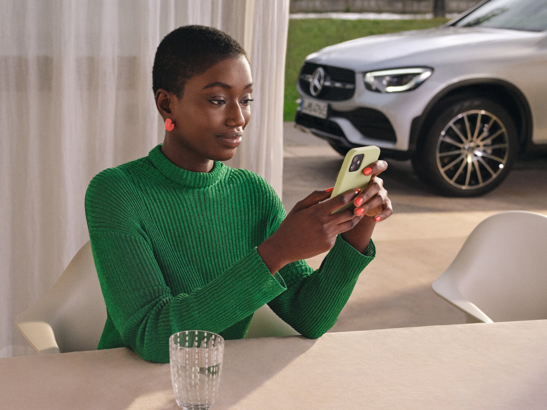 Woman checking the status of her vehicle on her smartphone.