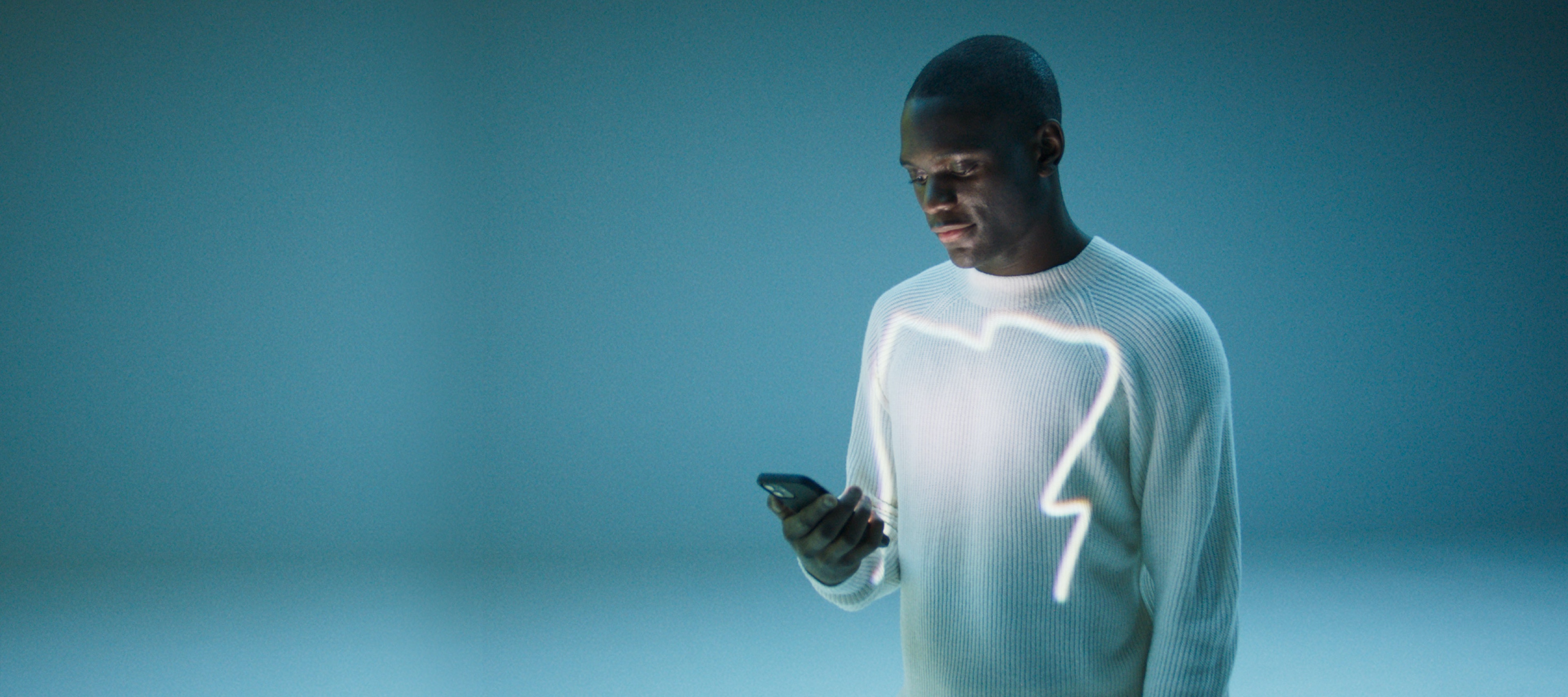 A man opens the Mercedes-Benz App on his smartphone. A man opens the Mercedes-Benz App on his smartphone.