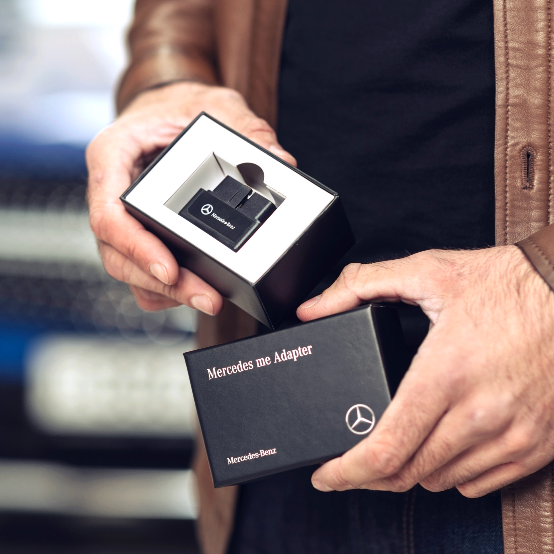 A man unpacks the Mercedes me Adapter for his Mercedes-Benz to be able to use Digital Extras in his vehicle. A man unpacks the Mercedes me Adapter for his Mercedes-Benz to be able to use Digital Extras in his vehicle.
