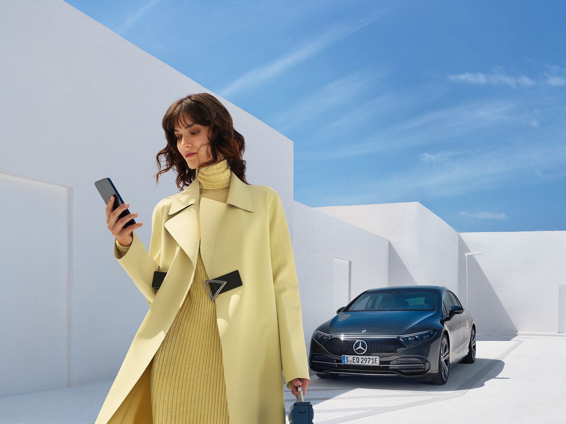 Woman extending/purchasing Digital Extras for a vehicle using a smartphone.