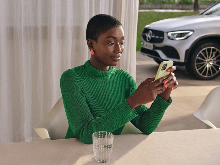 Woman sitting at table using app