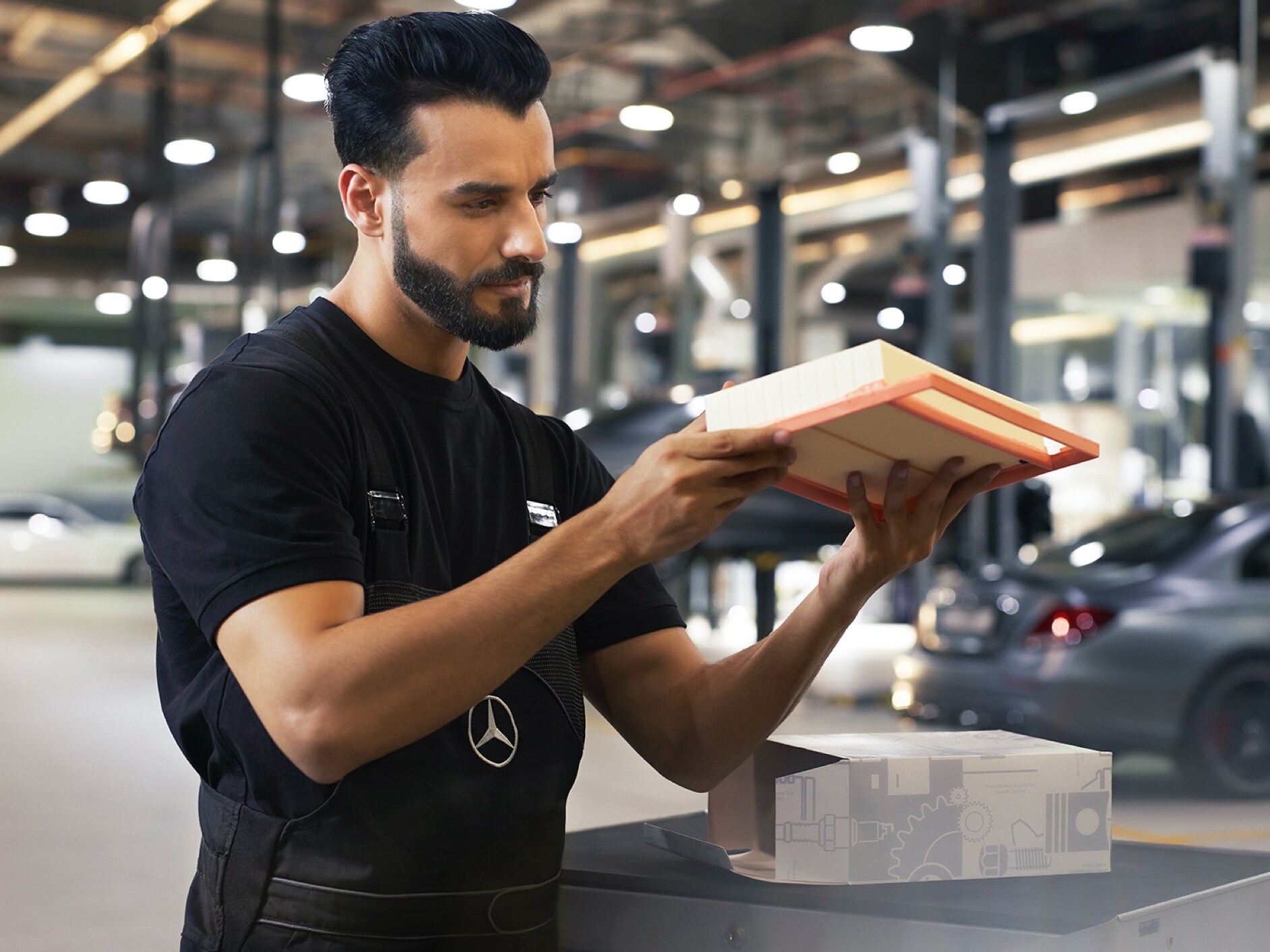 A Mercedes-Benz technician inspects an engine air filter.