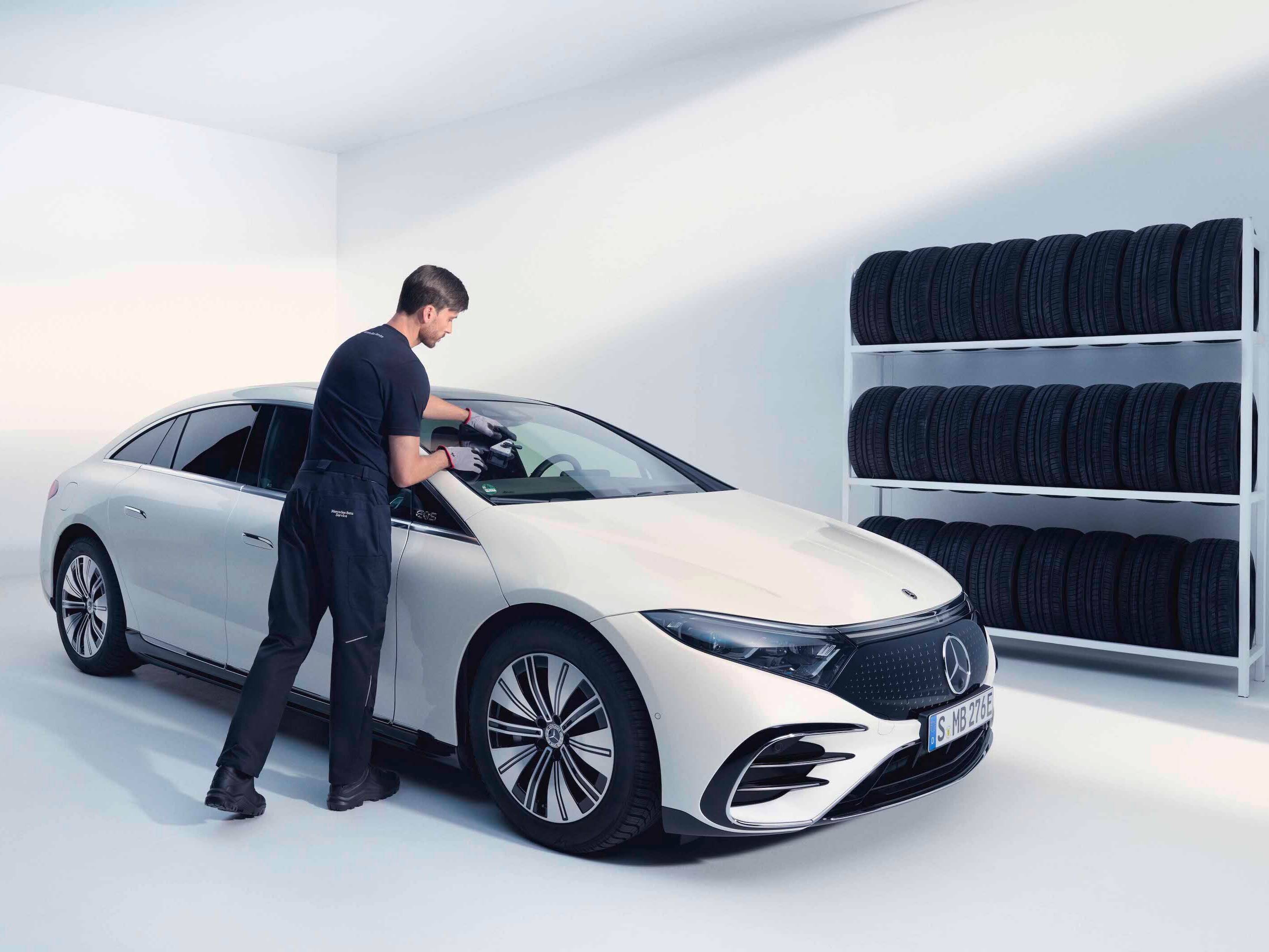 A technician checks the windshield of a Mercedes-Benz.