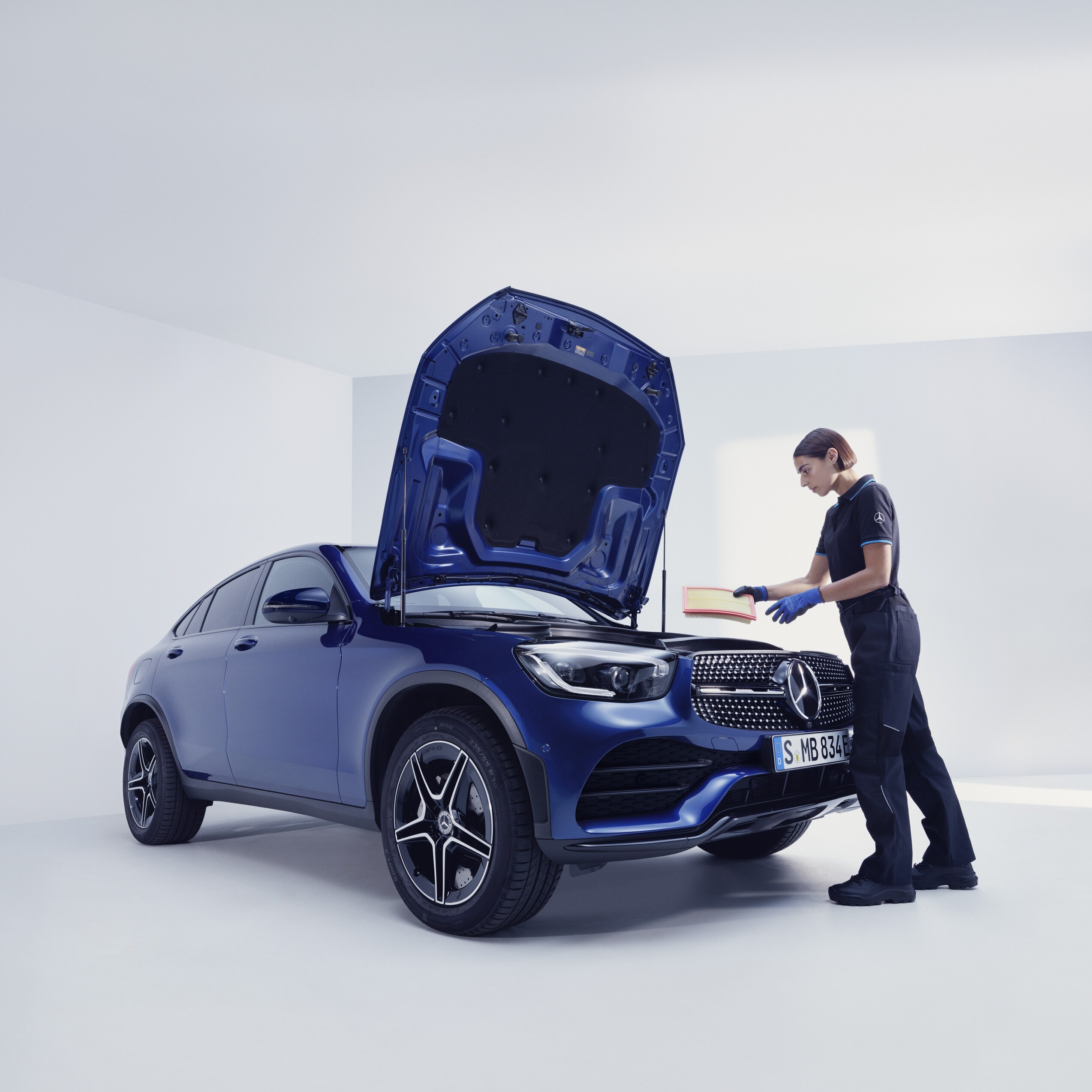 A Mercedes-Benz mechanic examines a Mercedes-Benz.