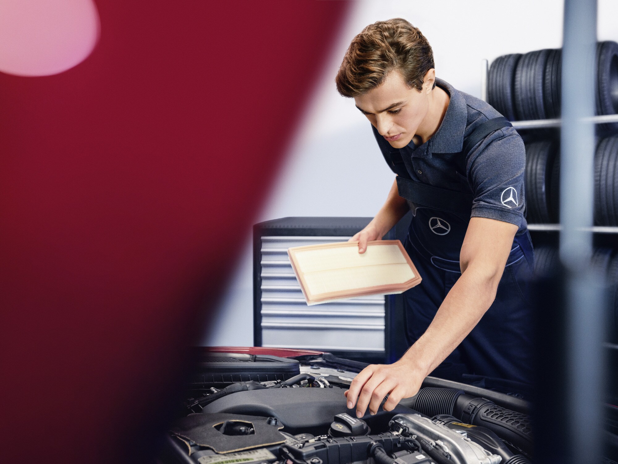 A Mercedes-Benz technician performs oilcheck.