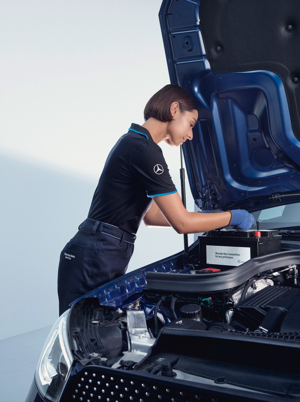 A Mercedes-Benz technician performs a replacement on a Mercedes-Benz.