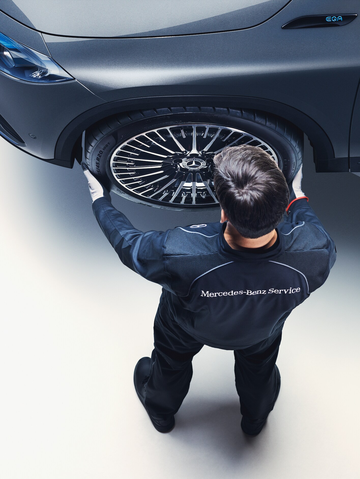 A Mercedes-Benz technician performing a tyre change.