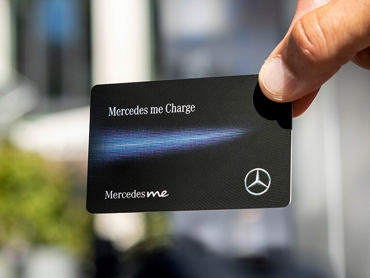 A man charging a Mercedes-Benz electric car at an IONTIY charging station.