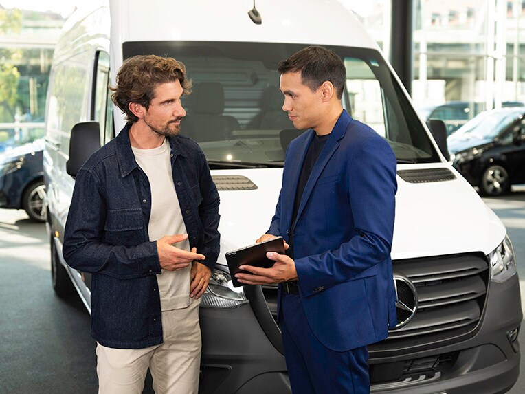 A customer talking to Business Manager in Mercedes-Benz showroom