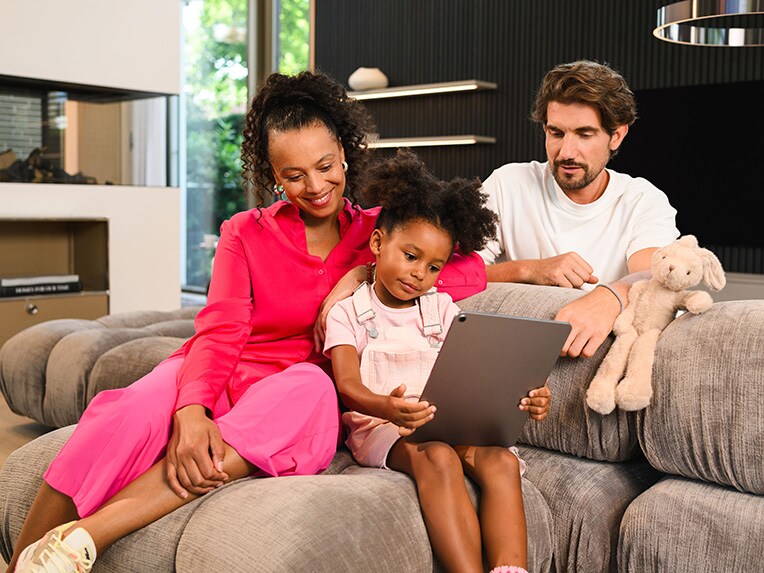 Family looking at Mercedes- Benz vehicles together on the couch