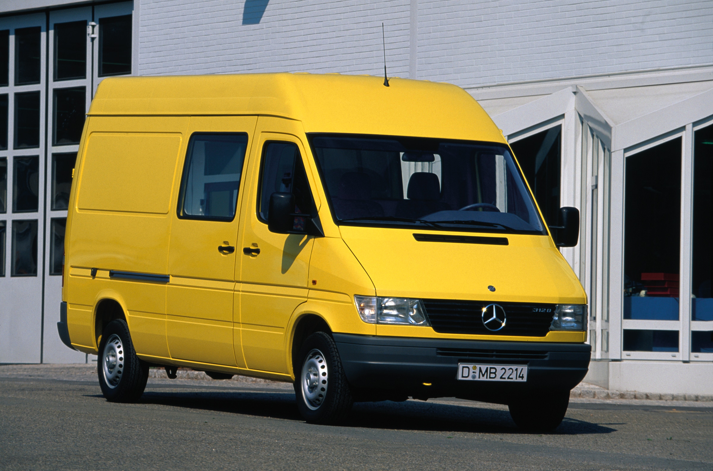 The first generation of Mercedes-Benz Sprinters | Commercial Vehicles History | Mercedes-Benz First generation Sprinter parked outside industrial building
