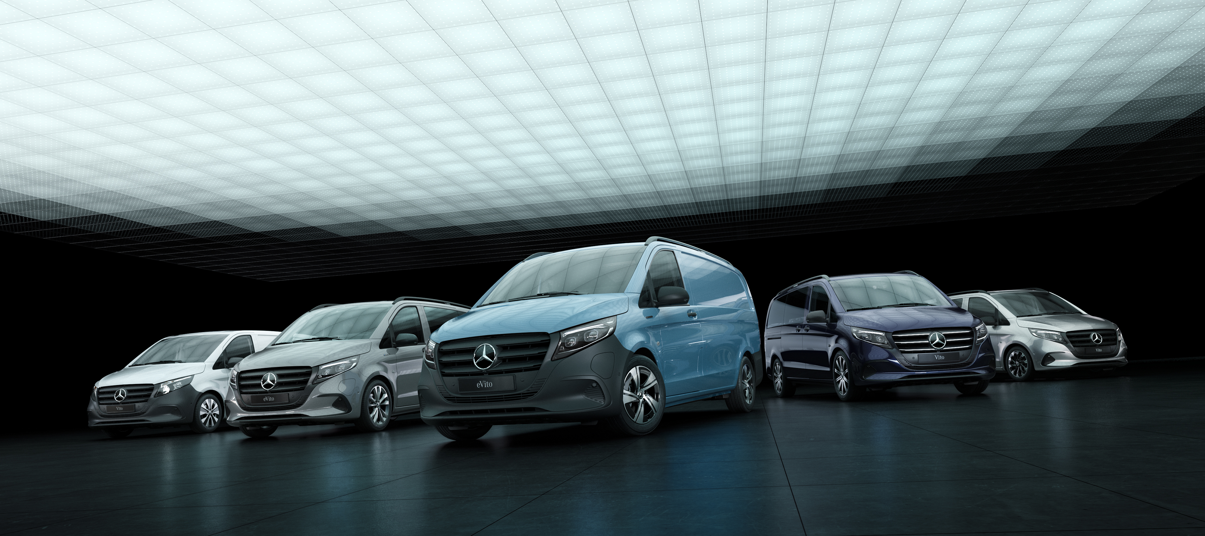 Vito and eVito | Mercedes-Benz Vans The new Mercedes-Benz eVito and Vito models are on display in an atmospherically lit hall.